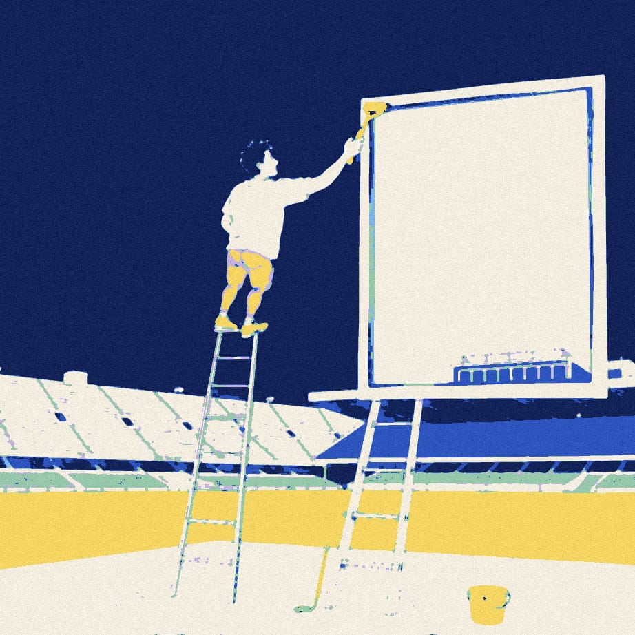 A small anonymous fan on a tall stepladder squeegees a gigantic window in front of a stadium, with a bucket of suds at the base.