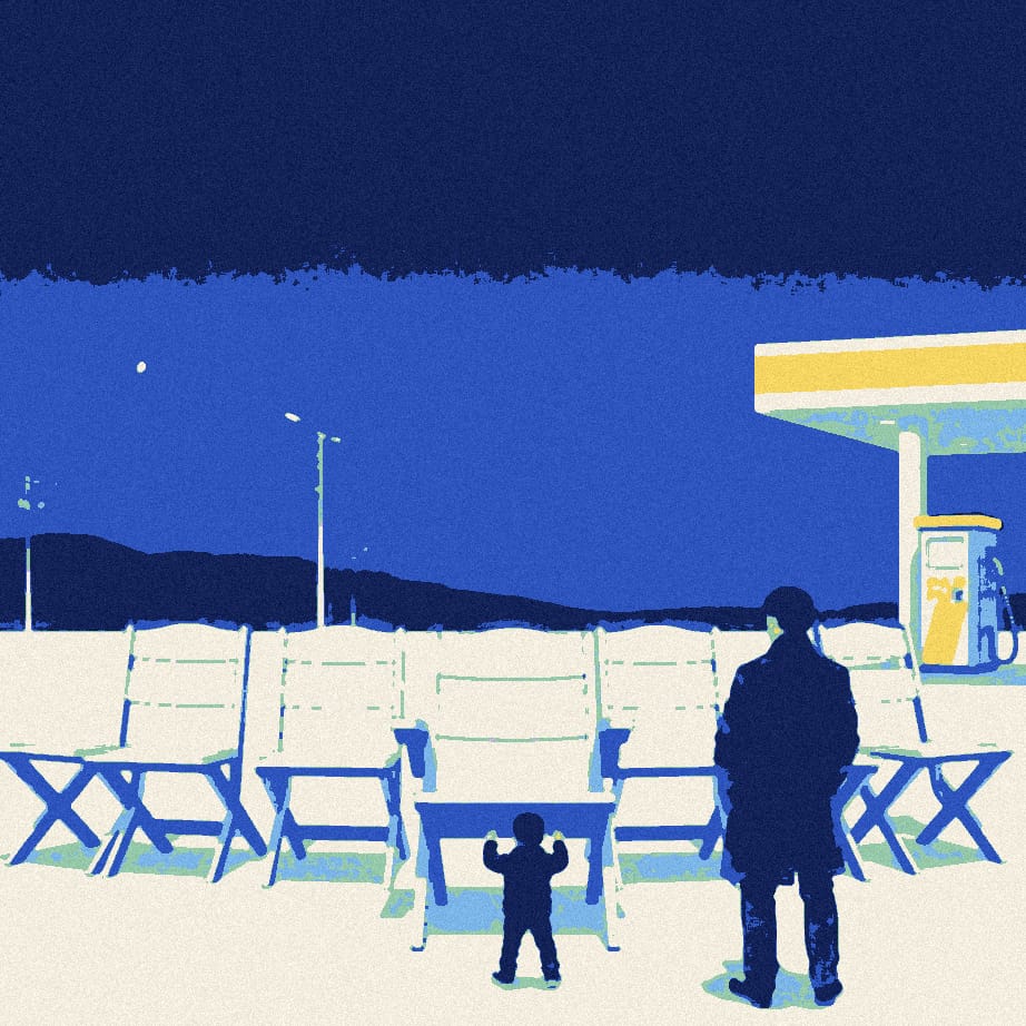 A small figure in a padded coat carries chairs across a night-time petrol station forecourt, where a row of eleven chairs waits beside one empty seat.