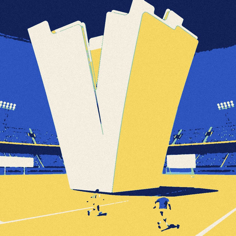 Two tiny faceless footballers sprint past four enormous blank index tabs standing on a night-time pitch.