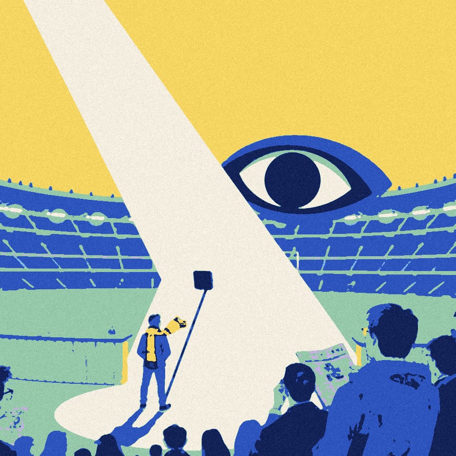 A tiny supporter seen from behind hides beside a lamppost outside a huge stadium while a giant spotlight points the other way.