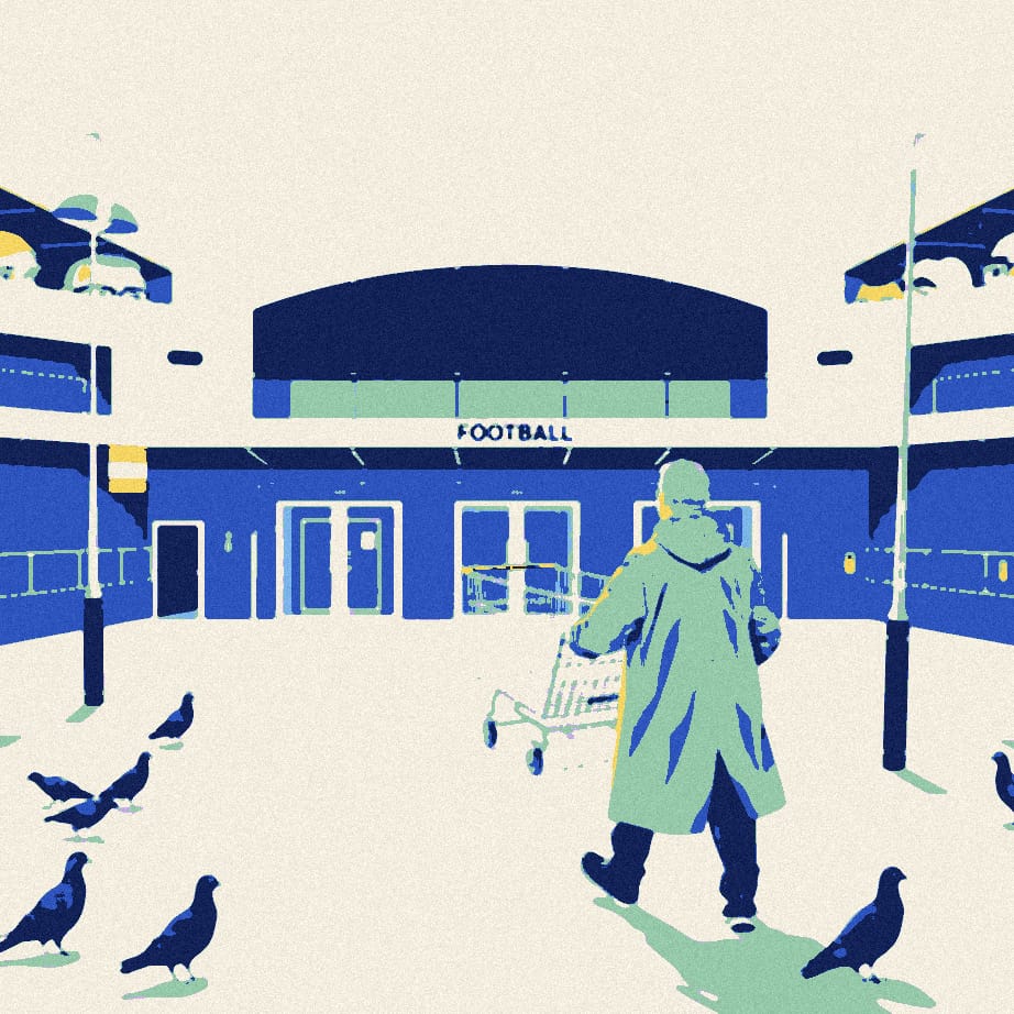 A lone man pushing an oversized shopping trolley across an empty forecourt towards the closed gates of a football stadium